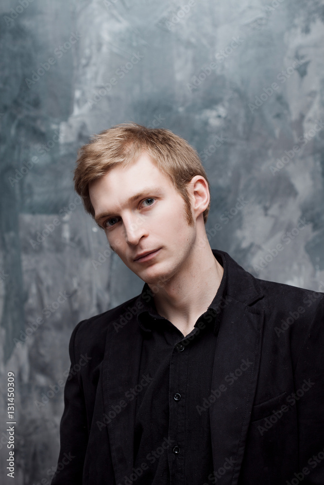 young man in jacket thoughtfully looks into the camera young man in jacket thoughtfully looks into the camera