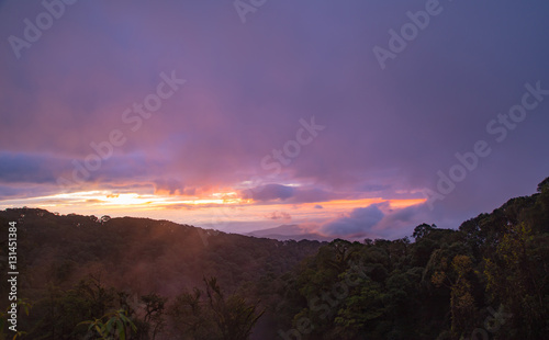 Mountains at sunrise with fog and mist in the valleys