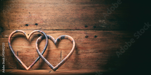 3d rendering joined hearts on wooden background