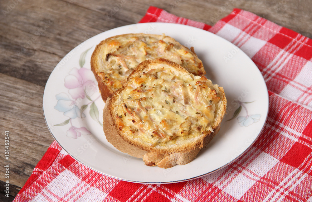 Baked bread slices with button mushroom, yellow cheese and ham dressing Baked bread slices with button mushroom, yellow cheese and ham dressing