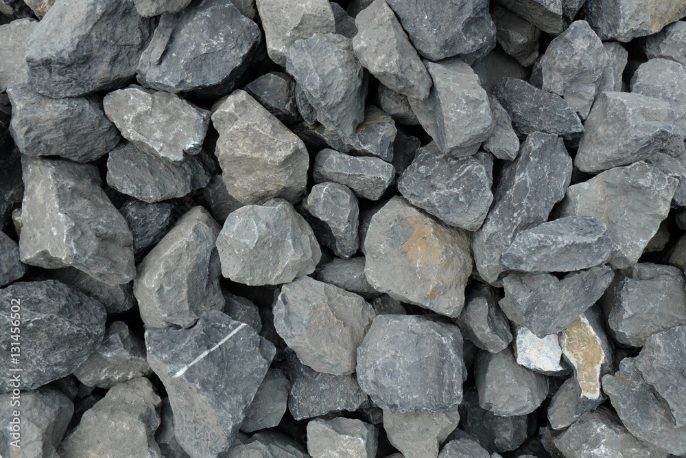 loose large stones - gray gavel aggregate of different sized stone pieces crushed and broken into irregular shapes and sizes at a stonepit. loose large stones - gray gavel aggregate of different sized stone pieces crushed and broken into irregular shapes and sizes at a stonepit.