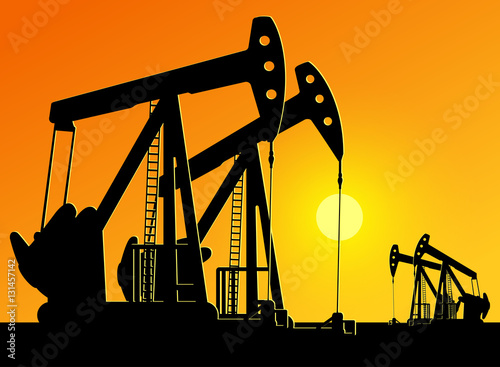 silhouette of working oil pumps on sunset background