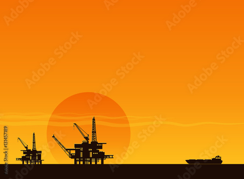 silhouette of working oil pumps on sunset background