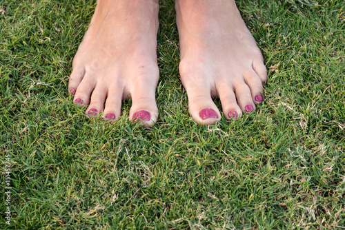 female feet in the grass