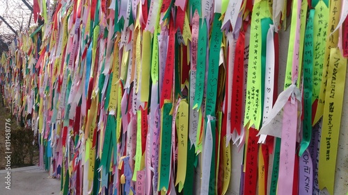Prayer ribbons attached to a barbed wire fence near the border between North and South Korea,  told they have messages of hope, dreams wishes for unification .