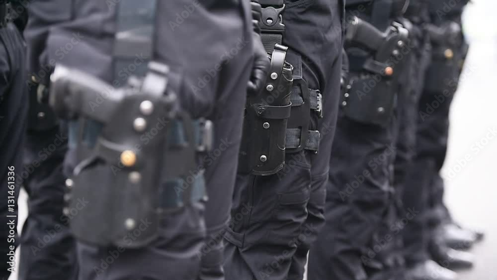 Soldier hand in black glove holding automatic machine gun during a military parade Soldier hand in black glove holding automatic machine gun during a military parade
