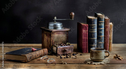 Cup of Coffee , old books , and coffee machine