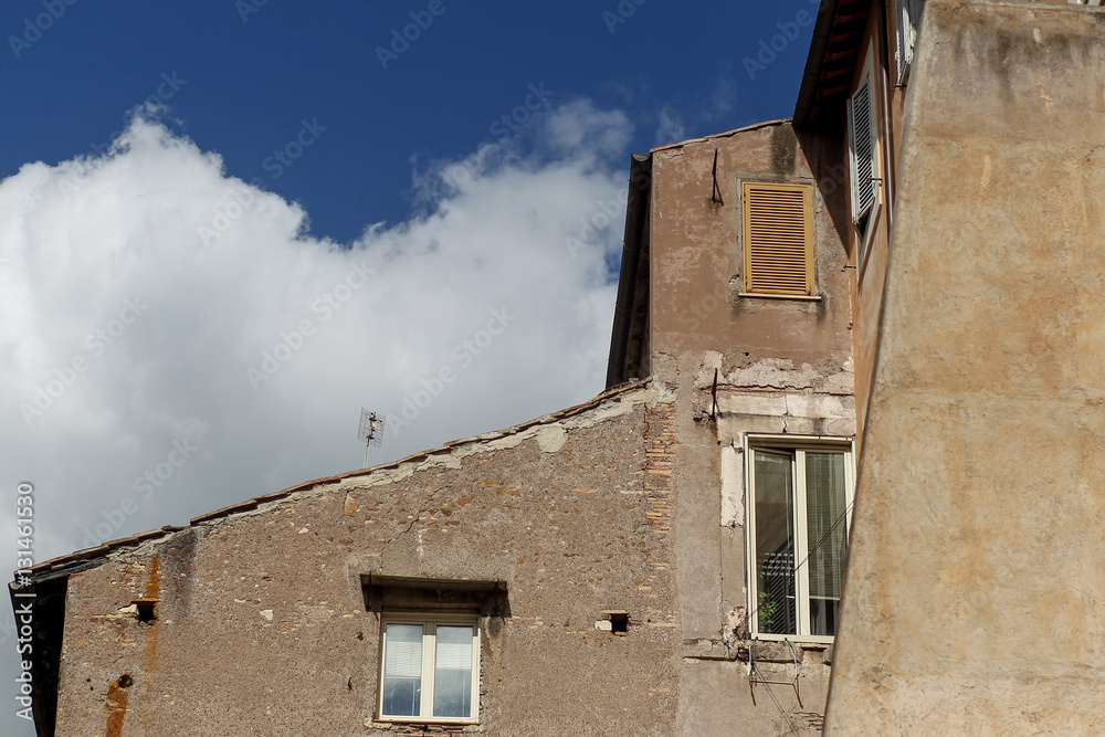 Building facade with windows, on blue sky, Rome, Italy
