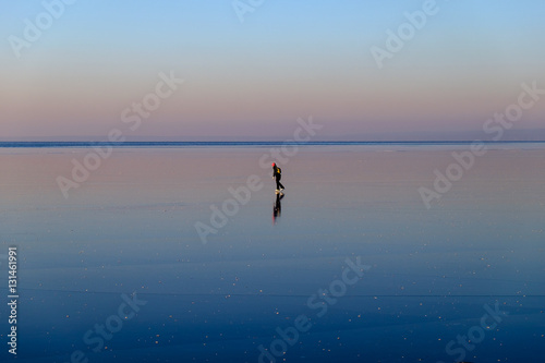 Girl skating on the frozen lake.