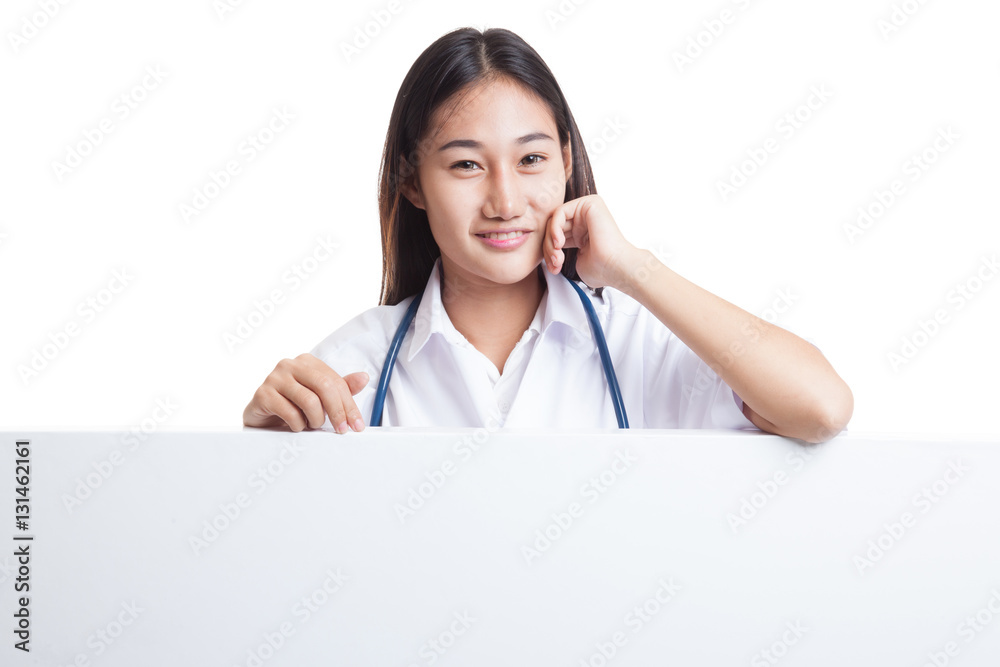Young Asian female doctor standing behind blank white billboard. Young Asian female doctor standing behind blank white billboard.