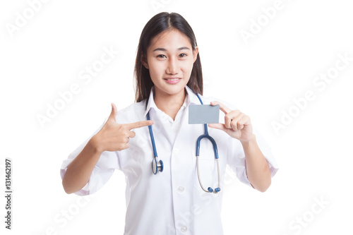 Asian young female doctor point to blank card.