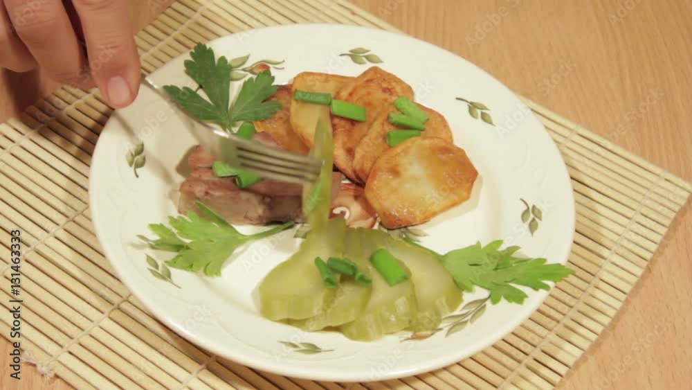 Man eating dish of potatoes with roasted meat. Very tasty homemade food Man eating dish of potatoes with roasted meat. Very tasty homemade food