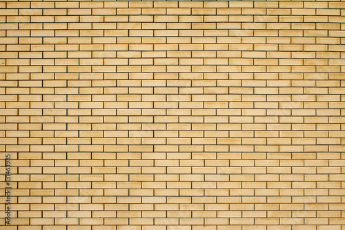 High resolution texture of a yellow brick wall. Laying horizonta