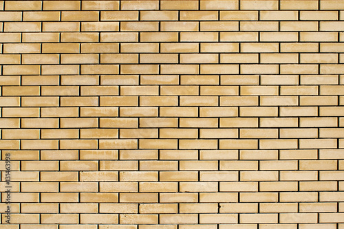 High resolution texture of a yellow brick wall. Laying horizonta