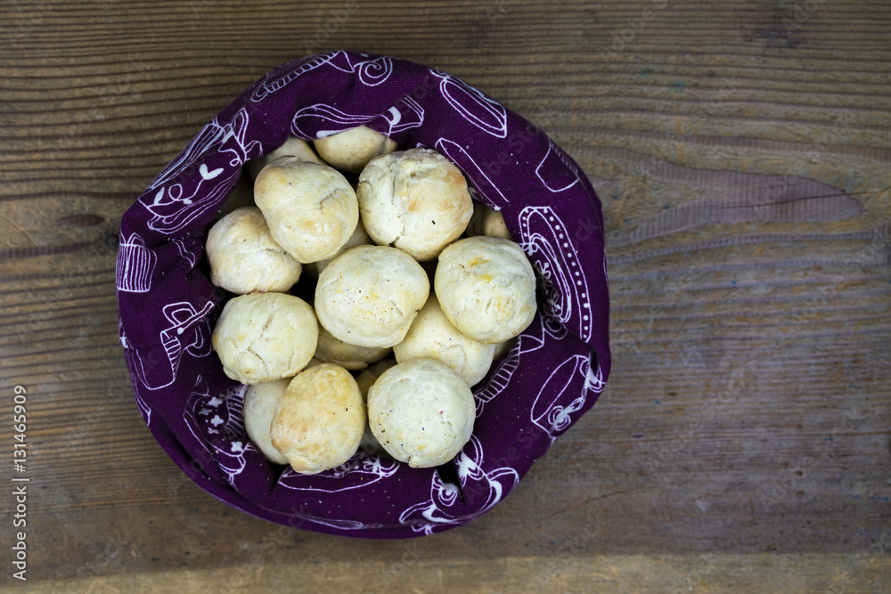 Overhead view of freshly baked bread buns in a bag on wood table with copy space Overhead view of freshly baked bread buns in a bag on wood table with copy space