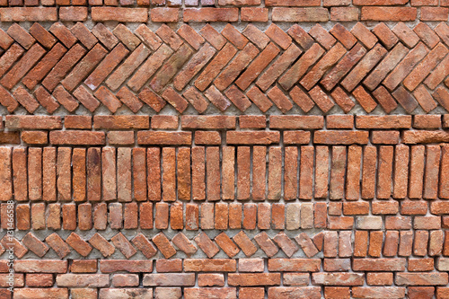 Old red bricks wall with an original design