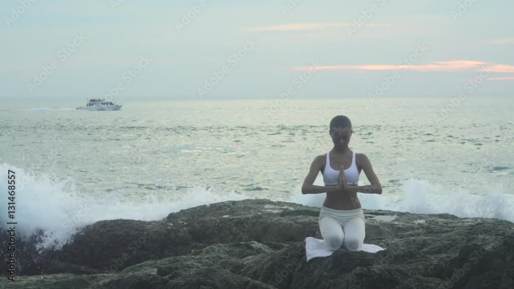 Woman Doing Yoga Exercise On Stone With Cloudy Sky Woman Doing Yoga Exercise On Stone With Cloudy Sky