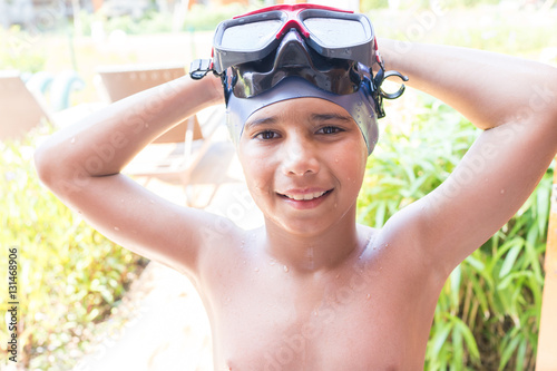Portrait of a kid laughing in a swimming pool