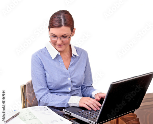 Fotografie Young businesswoman at work with compter and papers
