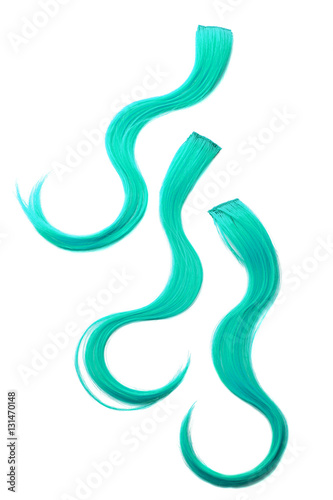 Three turquoise color hair pieces on background