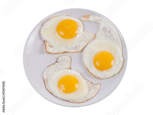 Tree sunny side up eggs on plate isolated