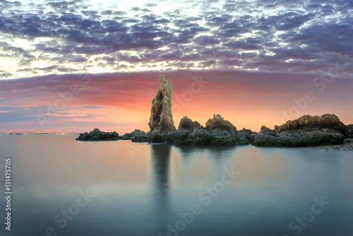 a pillar stay lonely in the sea shore of east part of Thailand in Sunset Scenery photo