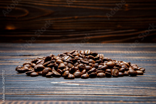 roasted coffee beans on wooden background © Anatoly Repin