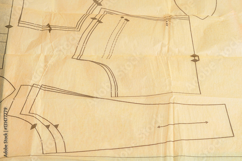 A piece of wrinkled paper with a pattern for making clothes