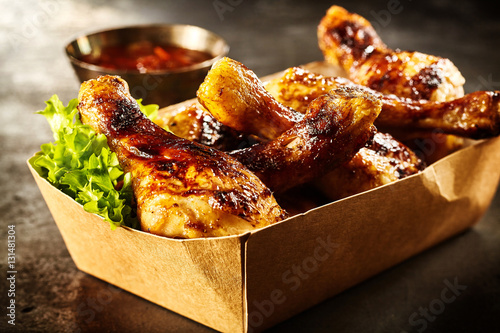Takeaway box of crispy grilled chicken legs