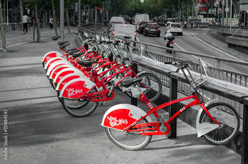 Canvas Print Grey and red image of Barcelona city bikes, Spain