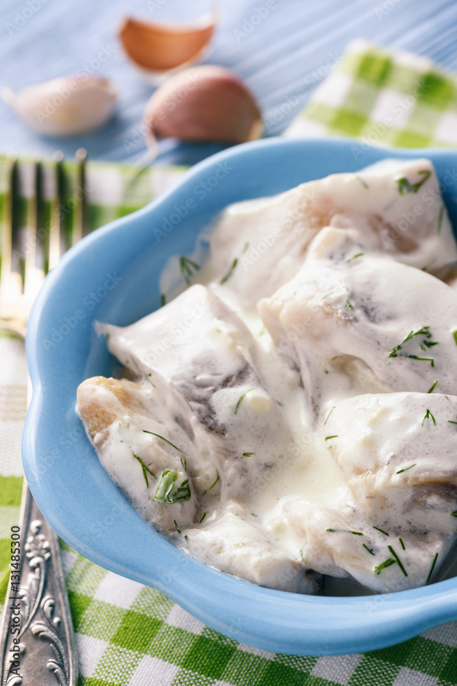 Herring in sour cream sauce with dill. Stock Photo Adobe Stock