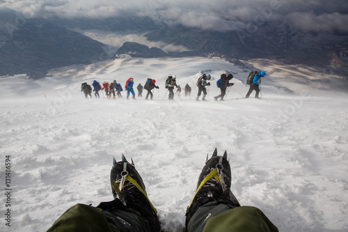 A group of alpinists in the snowy storm. Elbrus mountain, Russia