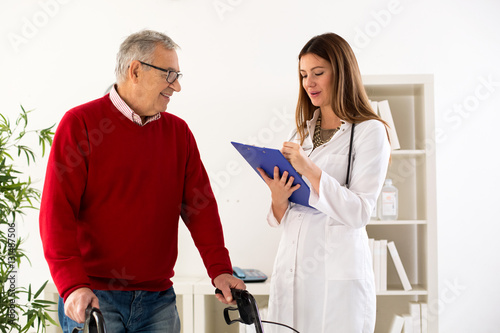 Senior man with walker on consultation with doctor