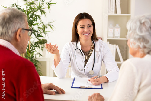 Senior couple on consultation with a doctor photo