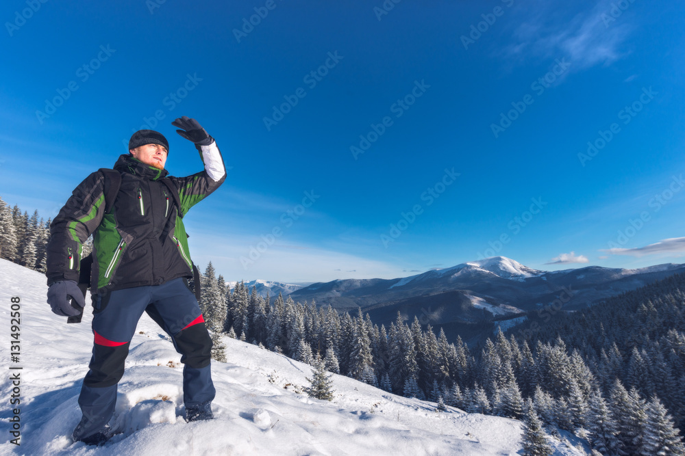 Traveler considers the way in the mountains in winter