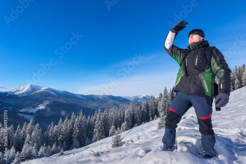 Traveler considers the way a hand up in the mountains in winter