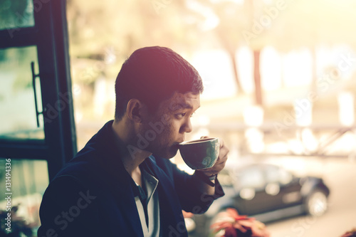 Bilde på lerret Young businessman looking to relax from work by sipping coffee.