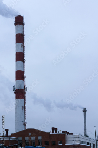 high pipe CHP on the background of blue sky, fog, smog