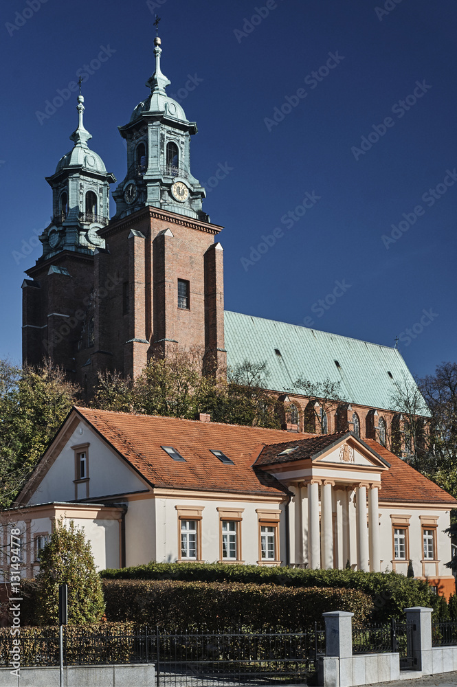 Neoclassical house and towers of the Basilica Archdiocese of Gniezno.