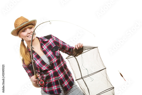 Happy woman holding fishing rod and keepnet photo