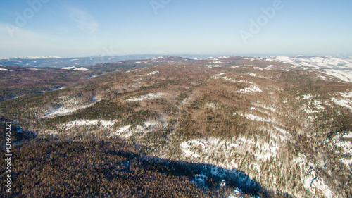 Russian Ural mountains in winter. Aerial view lake, white infinity photo