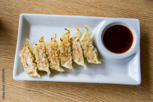 Asian appetizer menu fried dumplings with soy sauce Japanese tone photo