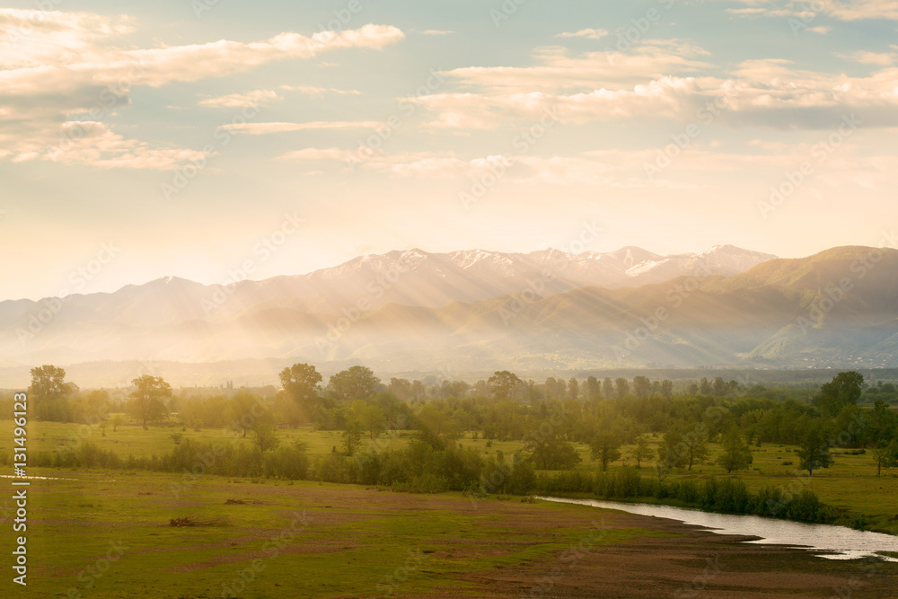 Obraz premium Valley view from the river and the mountains in the background at sunrise. Georgia. Caucasus mountains