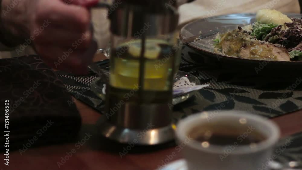 Person eating salad in a cafe.