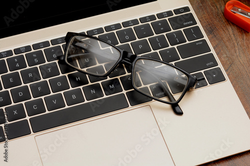 Businessman EyeGlasses on laptop keyboard