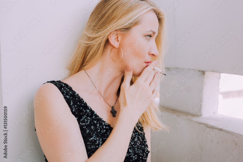 Φωτογραφία Girl with long legs in the way rock stars. Rocker girl smokes a