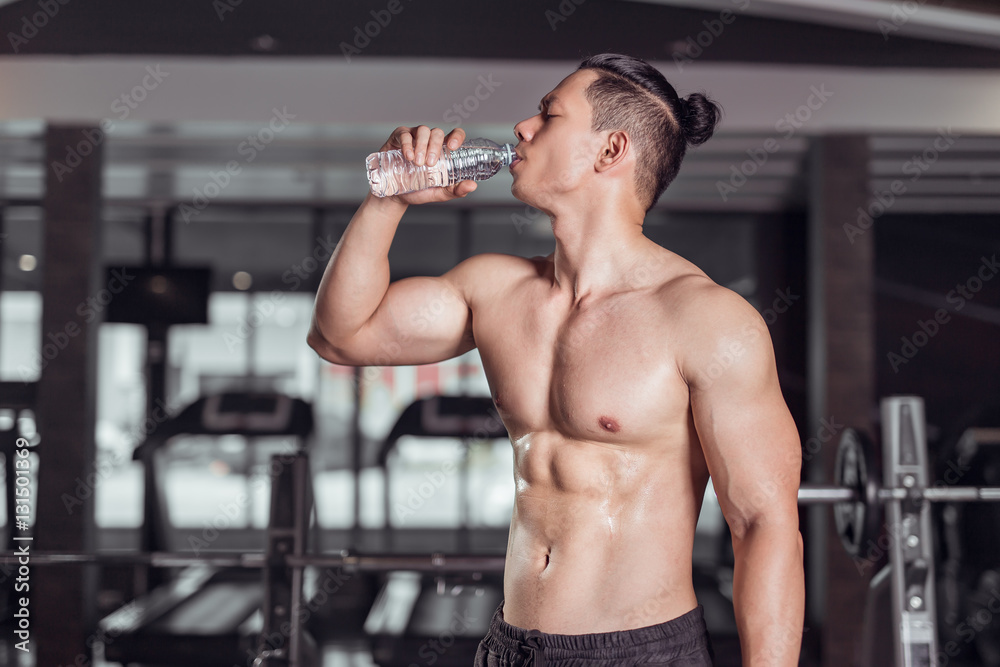 man drinking water in fitness gym man drinking water in fitness gym
