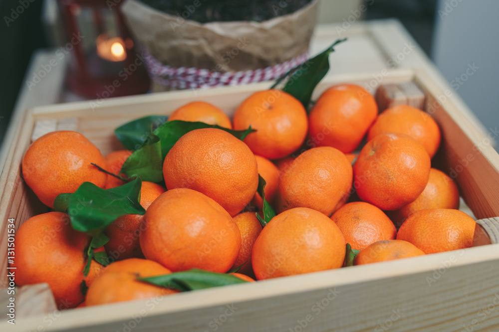 Wooden box of fresh mandarin fruits
