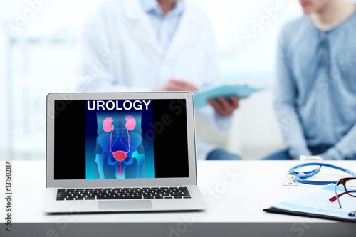 Laptop on table. Urinary sy...