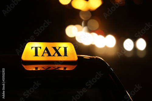 Taxi car on night street, close up view © Africa Studio